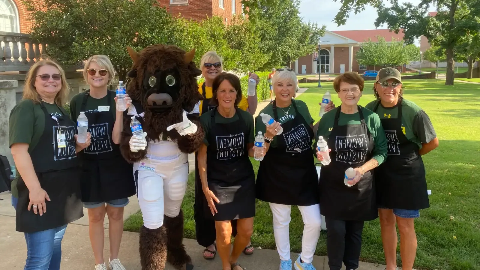 women of vision passing out water